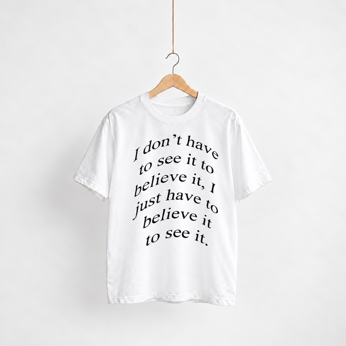 Believe white unisex graphic T-shirt — front view on a hanger