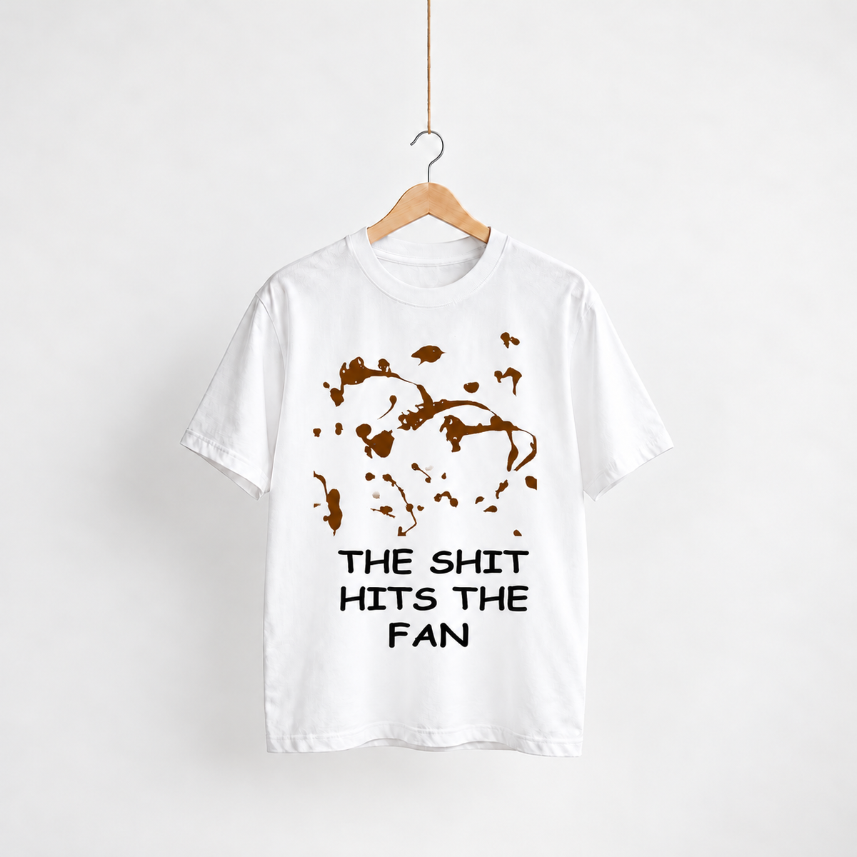 The Shit Hits the Fan white unisex graphic T-shirt — front view on a hanger