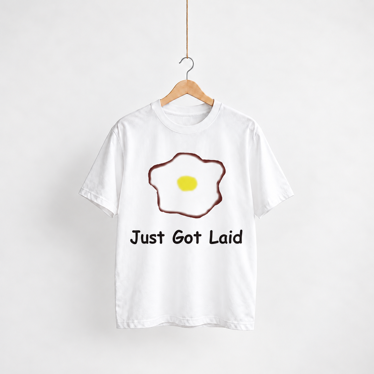 Just Got Laid white unisex graphic T-shirt — front view on a hanger